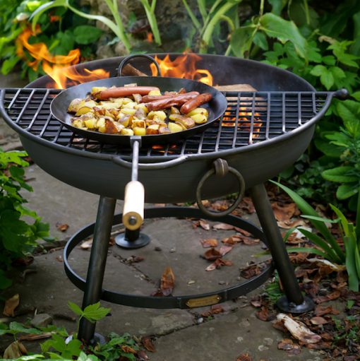 Fire Pit Long Handled Pan - Fire Pit Long Handled Pan These versatile long handled pans come in two sizes and are an essential piece of equipment for the fire pit cook. <div id="info"> The Firepits UK Long Handled Pan is highly versatile and can be used with both our fire pits and chimineas; simply place on the BBQ Rack. Made from mild steel they can be used for frying, griddling, sautéing and one pot dishes such as paella. The long wooden handle provides protection from the fire. </div> <h3><strong>Maintaining your fire pit</strong></h3> <strong>NB: All our fire pits, lids and accessories will begin to rust immediately and will not maintain their black finish. However, this will not affect their long term durability. As all our fire pits are handmade from sheet steel which has naturally occurring blemishes, there may be very slight variations in the forging and finish. </strong>